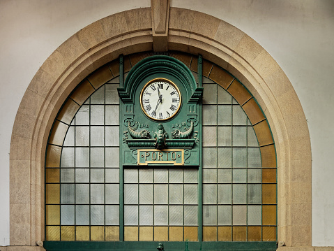 The old clock inside the hall of Sao Bento railway station in Porto, Portugal