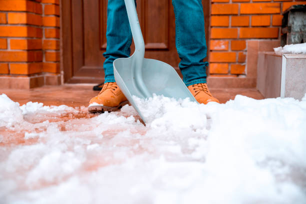 Cleaning the snow with plastic shovel