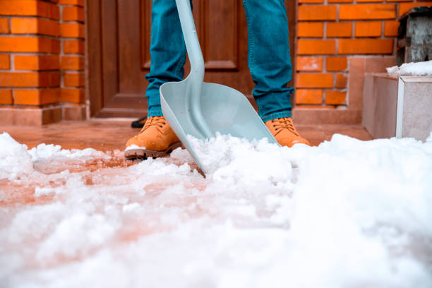 Cleaning the snow with plastic shovel Close up Snow shoveling tile floor on patio on winter day deep snow stock pictures, royalty-free photos & images