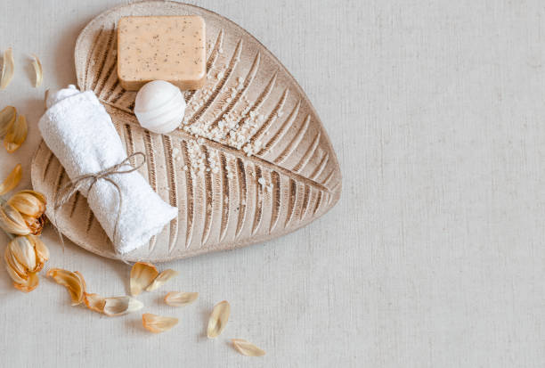 istock Spa composition with a bath bomb, soap and a towel on a ceramic base copy space. 1298341101