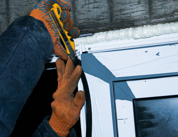 istock Construction worker installing window in house. Installation of insulating rubber for metal-plastic windows at low air temperatures. 1298342987