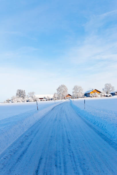 istock Icy and snow covered country road 1298344774