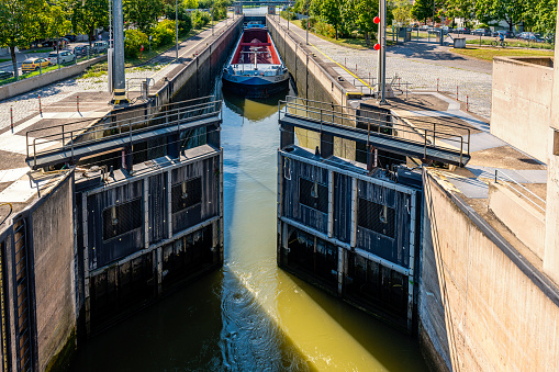 Regensburg, Germany - August 19, 2020: A container ship just going through a river lock in Regensburg.