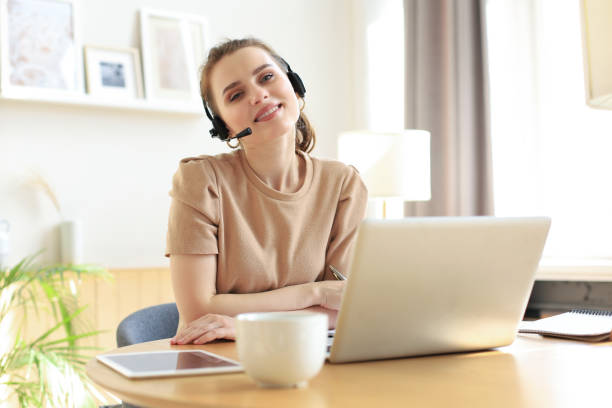 istock Freelance business women using tablet working call video conference with customer in workplace at home. 1298345120