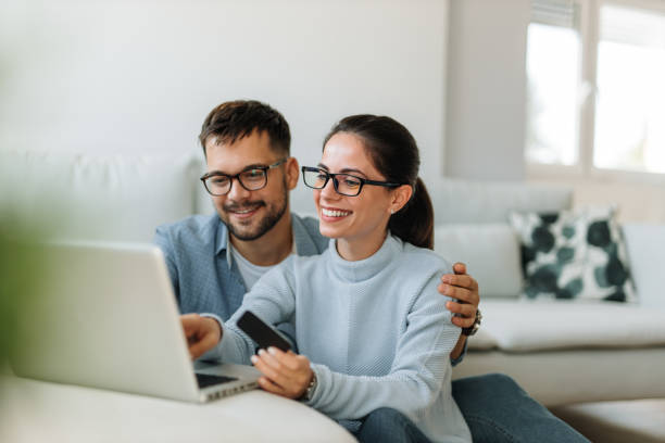istock Holding credit card, both wearing glasses. 1298347331