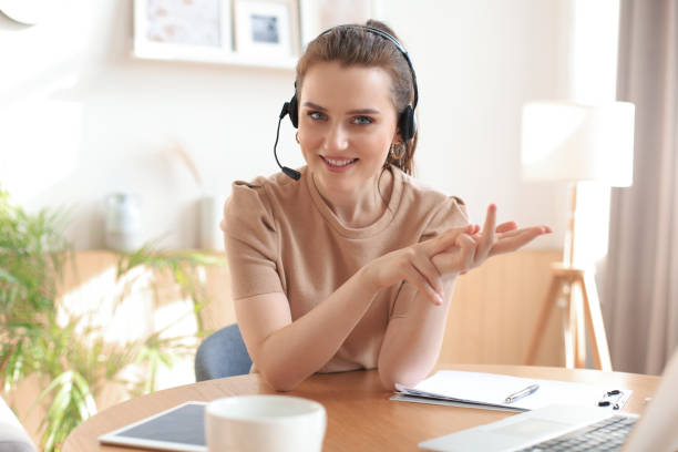 istock Freelance operator talking with headsets and consulting clients from home office. 1298347366