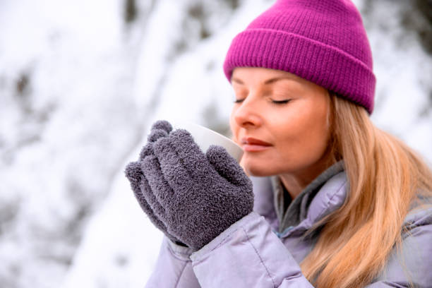 Woman warming with hot drink