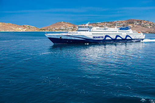 Paros island, Greece - July 03, 2018: View of part of Paros island in the Agean Sea, Greece. You can see in front of the islande the Tera Jet by Seajets ferry. The Tera Jet is a Ro-Ro fast ferry operating passenger and freight ferry services in the Aegean Sea.