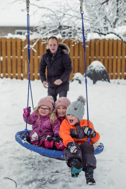 istock Parents with 3 kids playing outside winter snow 1298348523