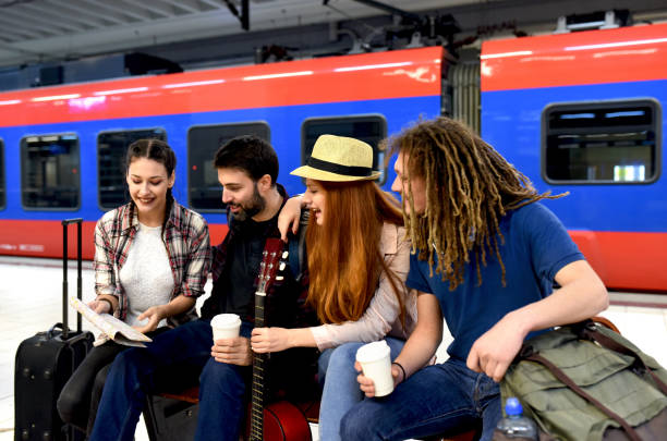 istock Few friends at the train station while waiting for a train for a long journey 1298348906