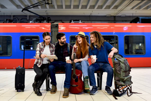 istock Few friends at the train station while waiting for a train for a long journey 1298348952