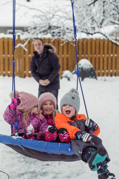 istock Parents with 3 kids playing outside winter snow 1298349157