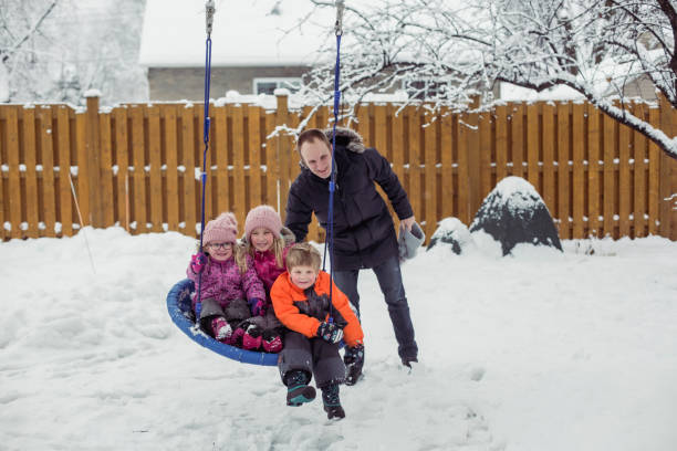 istock Parents with 3 kids playing outside winter snow 1298349753