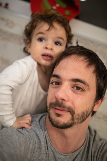 istock Father taking selfie with his little son at home 1298350431