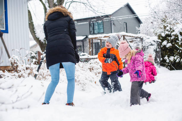 istock Family playing in the snow 1298350775