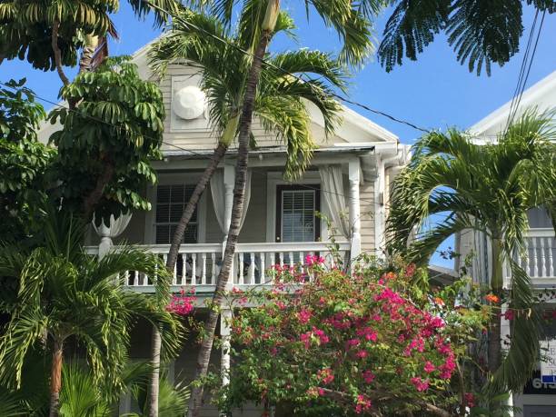 Key West Conch-Style Victorian architecture Key West Florida Jan. 2019 The quaint conch-style architecture with large front porch and balcony, white wooden siding and lush tropical gardens seashell island florida stock pictures, royalty-free photos & images
