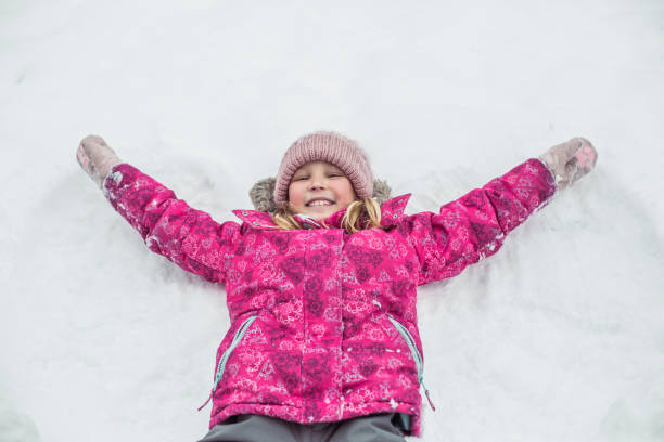 istock Young girl playing in snow 1298351398