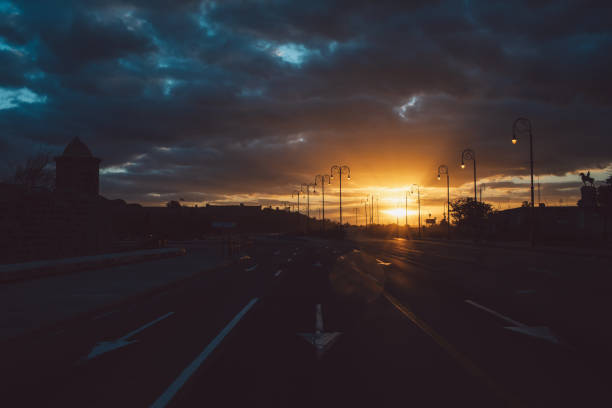 istock Road By City Against Sky During Sunset 1298351720