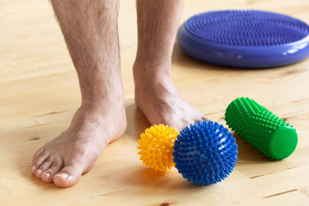istock man doing flatfoot correction gymnastic exercise using massage ball at home 1298351812