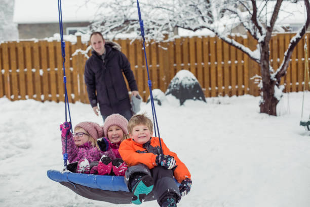 istock Parents with 3 kids playing outside winter snow 1298352060