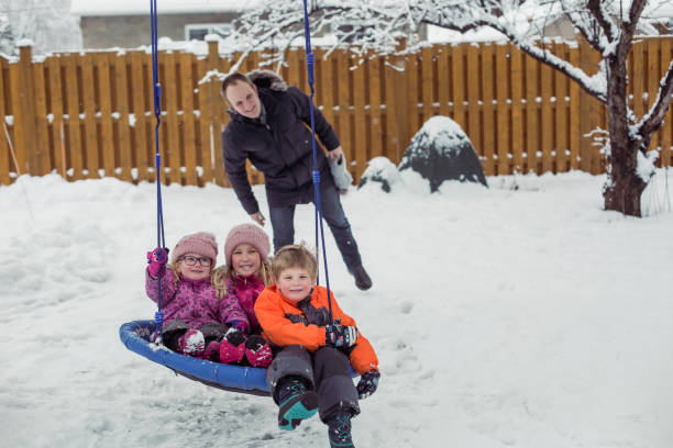 istock Parents with 3 kids playing outside winter snow 1298352921