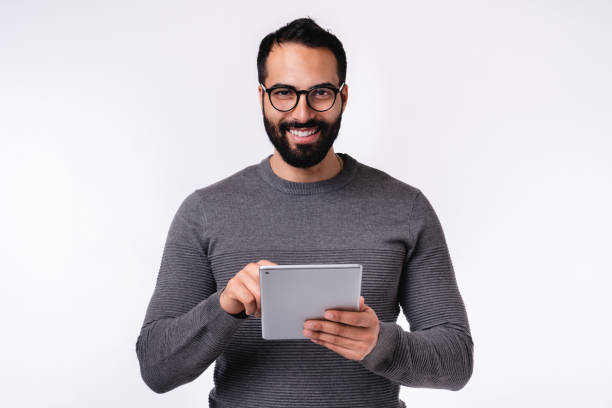 istock Middle East man in casual clothes using tablet isolated over white background 1298353777