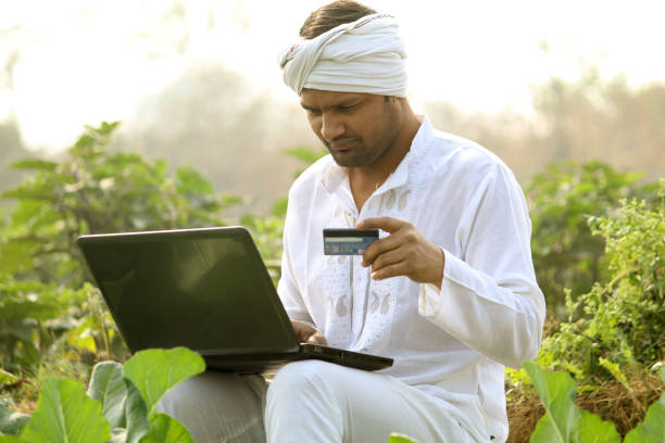 istock indian farmer using laptop.Credit Card, 1298354028