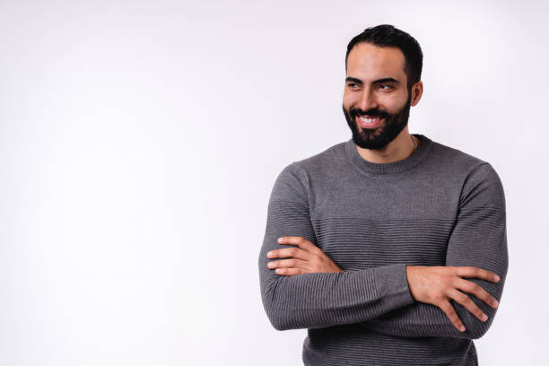 istock Confident smiling Middle Eastern man with arms crossed isolated over white background 1298354421