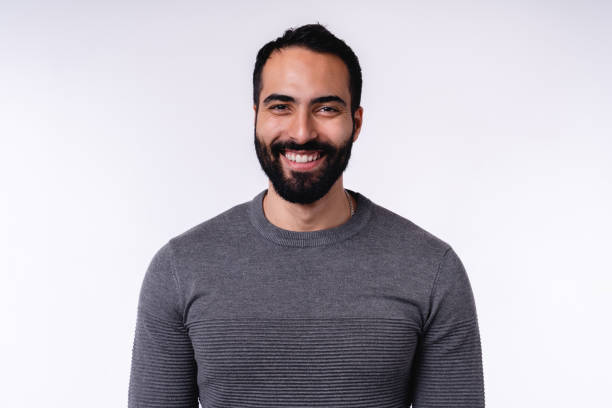 istock Smiling arab man in casual attire isolated over white background 1298355501