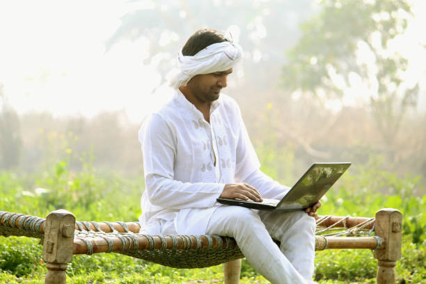 istock indian farmer using laptop.payment by using credit card - concept of rural people using technology, internet and lifestyle.turban 1298355509