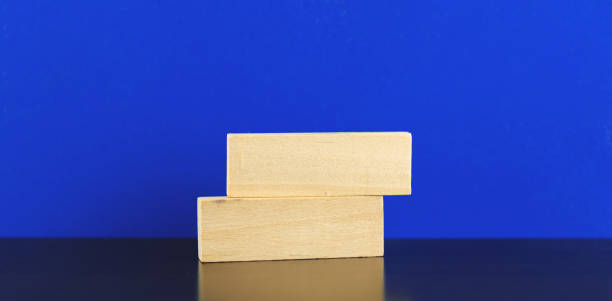 istock Business template, mockup, wooden pegs, blocks on a table, blue isolated background 1298355803