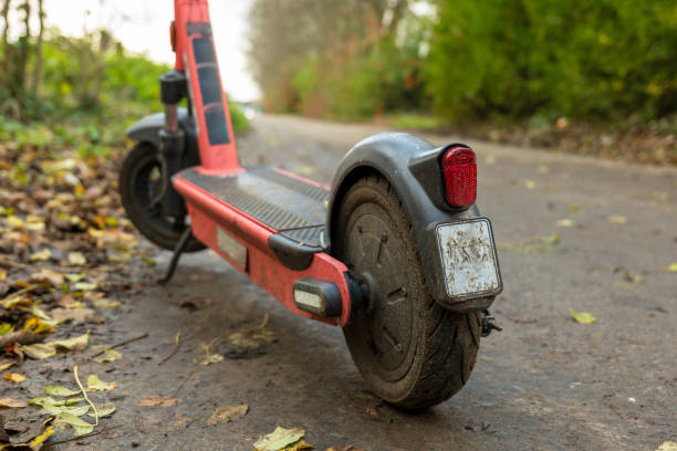istock Battery powered electric scooter vehicle left on pedestrian footpath in england uk 1298356599