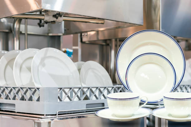 istock Plate cup set and many white plate on basket in automatic dishwasher machine for cleaning in kitchen room restaurant 1298356818