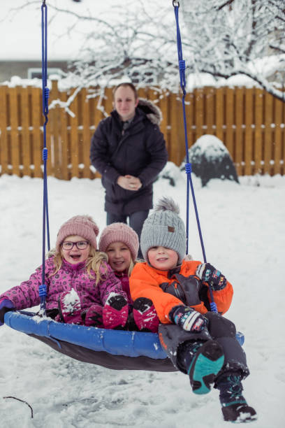 istock Parents with 3 kids playing outside winter snow 1298358229