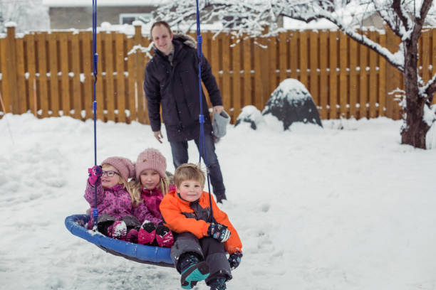 istock Parents with 3 kids playing outside winter snow 1298358235