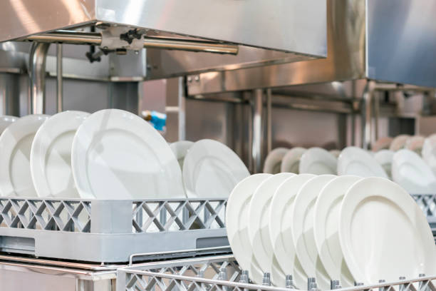 istock many white plate on basket in automatic dishwasher machine for cleaning in kitchen room restaurant 1298360265