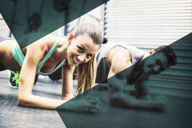 istock Muscular couple doing planking exercises 1298360997