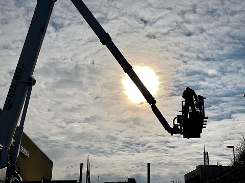 Brunssum, the Netherlands, - Januari 25, 2021. Mobile platform lifting up to maintain the Brunssum city hall.