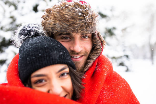istock A handsome young man hugging his girlfriend under a blanket 1298362499