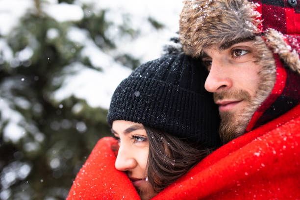 istock A beautiful couple enjoying a snowy day out under a blanket 1298362510