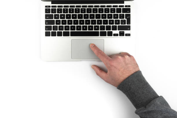 overhead view of person using touchpad or trackpad on laptop computer on white background