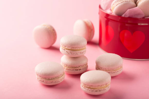 istock Rose macaroons present in red gift box on pink 1298368105