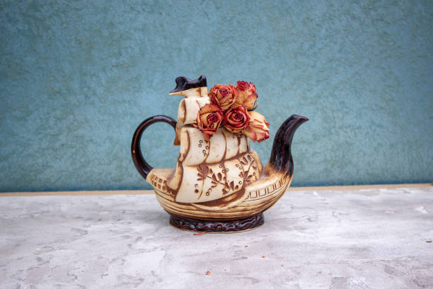 Porcelain teapot isolated on a blue background.