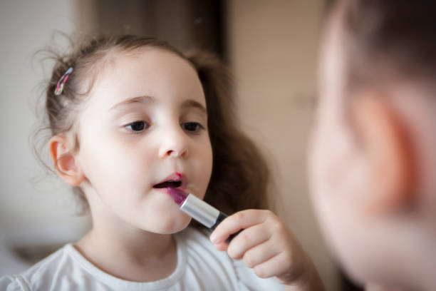 istock Little girl's first lipstick 1298371384