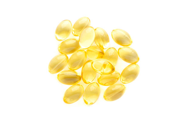 Fish oil gel capsules isolated on white background, top view. Pile of yellow fish oil capsules isolated on white background, top view. Omega-3 fish oil capsules. Close-up of yellow fish oil capsules. Fish oil gel capsules isolated on white background, top view. Pile of yellow fish oil capsules isolated on white background, top view. Omega-3 fish oil capsules. Close-up of yellow fish oil capsules Soft Gel stock pictures, royalty-free photos & images