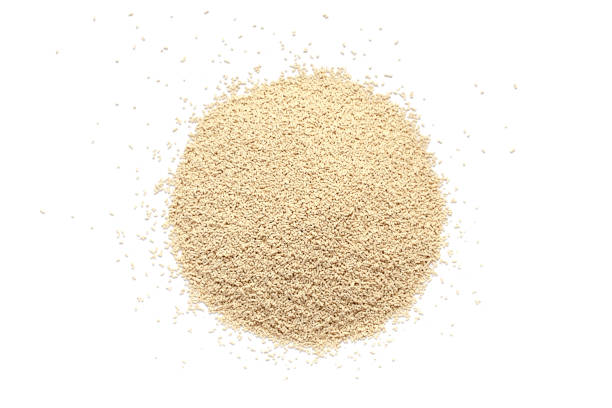 Pile of dry yeast isolated on white background, top view. Active dry yeast on a white background, top view. Dry yeast granules isolated on white background. Dry yeast is used in baked goods. Pile of dry yeast isolated on white background, top view. Active dry yeast on a white background, top view. Dry yeast granules isolated on white background. Dry yeast is used in baked goods yeast stock pictures, royalty-free photos & images