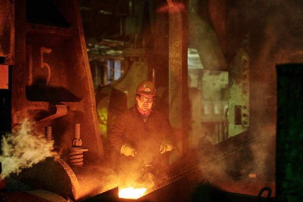 istock Worker controlling metal melting in furnaces 1298373206