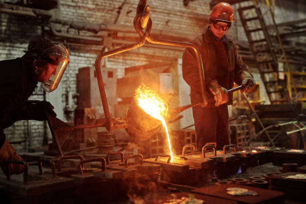 Steel workers in factory The welder works in the factory shop two steel workers melting metal foundry photos stock pictures, royalty-free photos & images