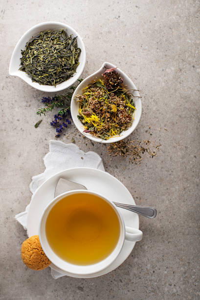 istock Tea cup with herbs and green tea leaves 1298373602