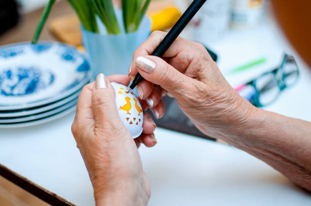 Two women holding just painted colorful Easter eggs